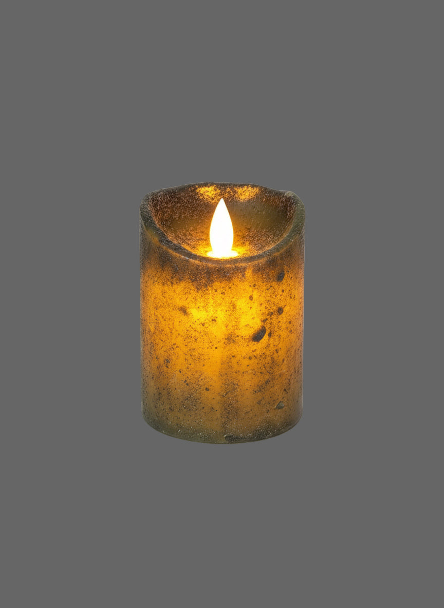 A pillar candle with a moving flame, placed on a dark green mat, with a grunge-style wall in the background.