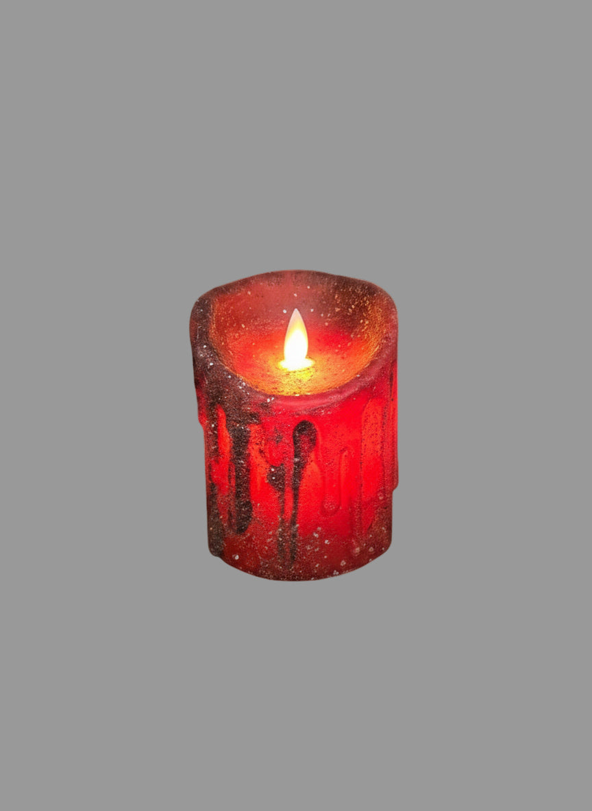 A red mica pillar candle on gray background