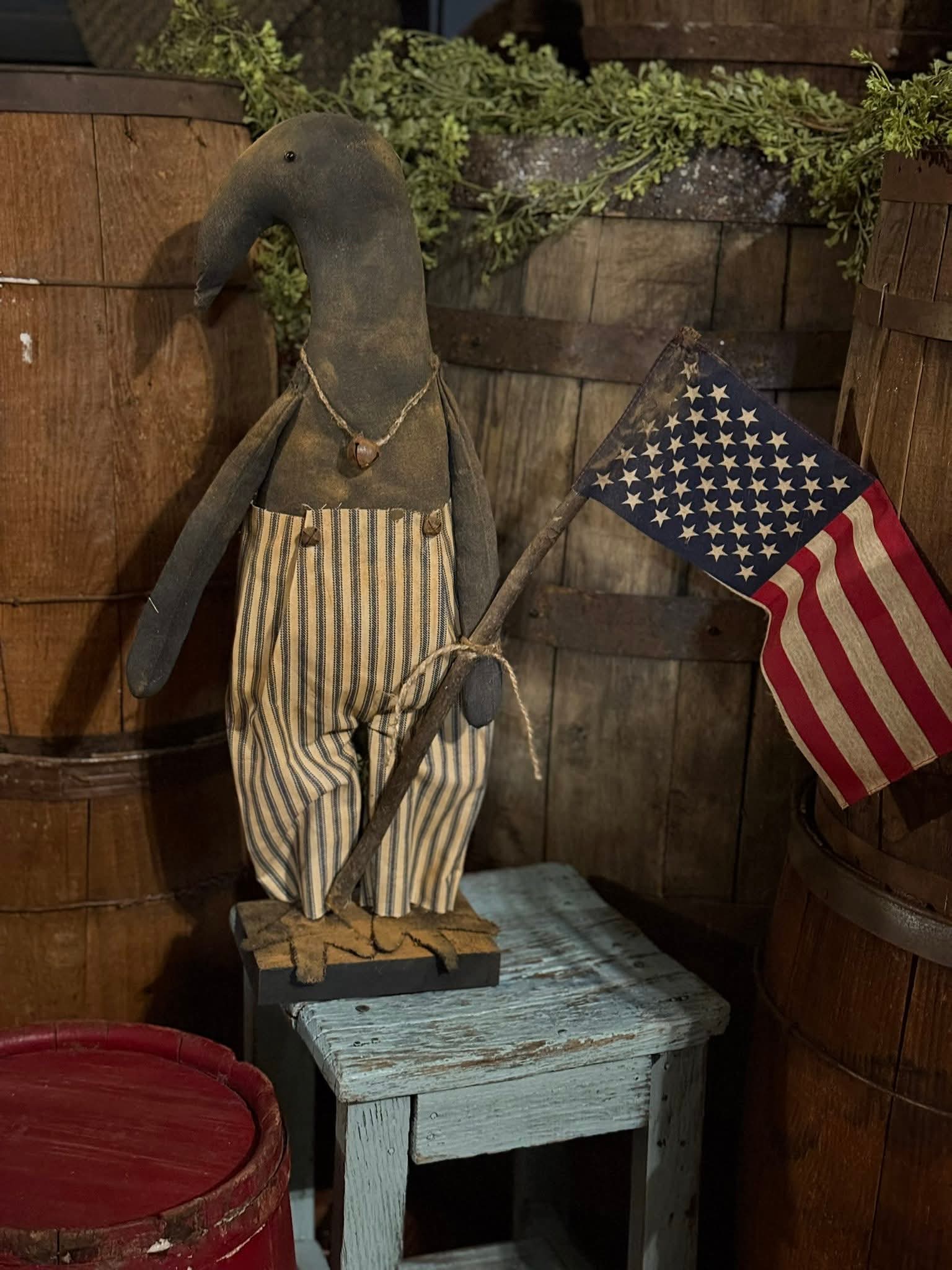 Vintage-style figure with American flag and wooden barrels in the background