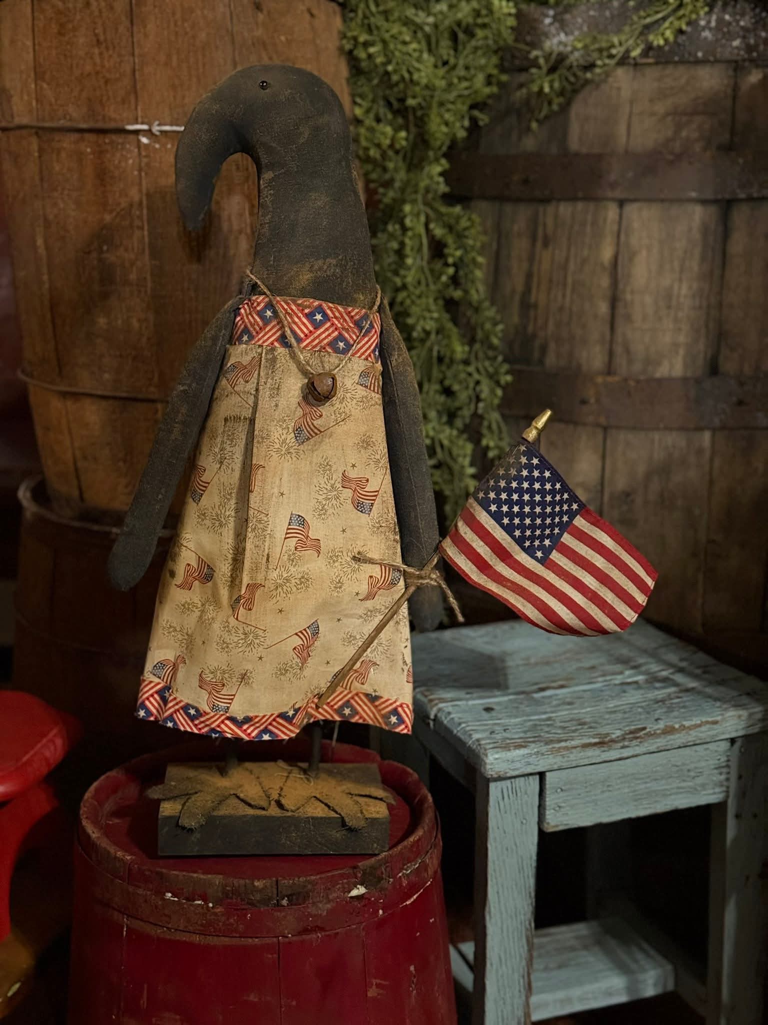 Decorative hook with American flag design on a rustic wooden background