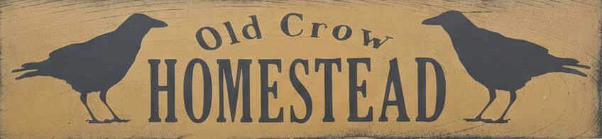 Wooden sign with 'Old Crow Homestead' text and crow illustrations on a mustard background