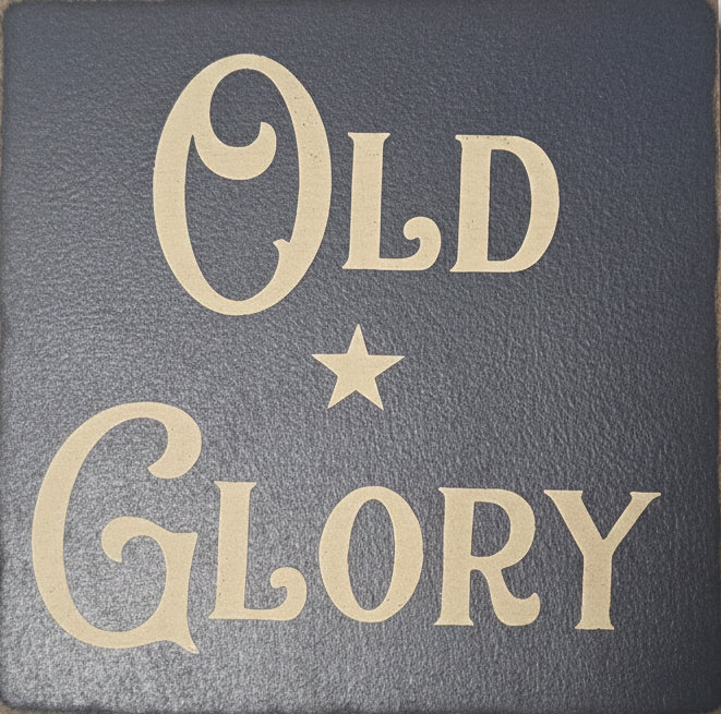 Text 'Old Glory' with a star on a textured gray background
