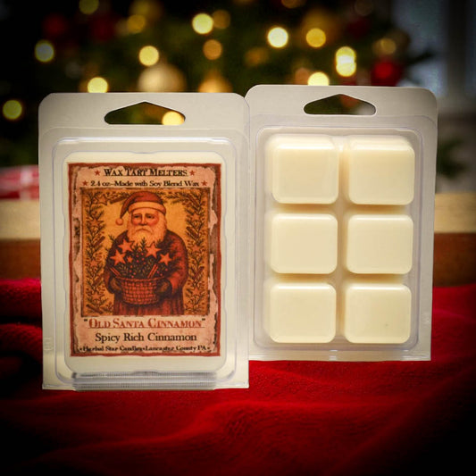 Wax tart melt package with 'Old Santa Claus' design on a red fabric background.