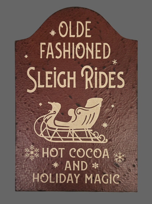 Decorative sign with text about hot cocoa and holiday magic on a burgundy background