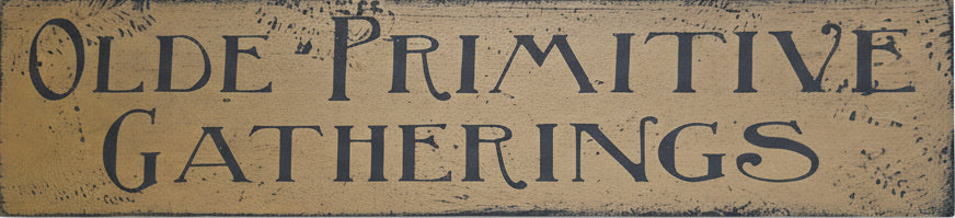 Wooden sign with 'Olde Primitive Gatherings' text on a rustic background