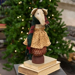 Olde Thyme Christmas Mouse in a patterned tan dress and plaid scarf, perched on a pincushion with a lit Christmas tree behind it
