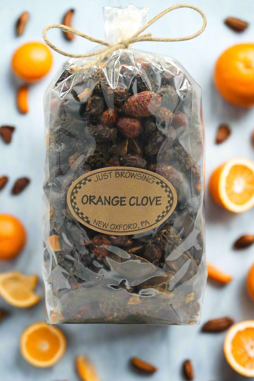 Orange clove potpourri surrounded by oranges and cloves