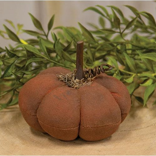 Orange distressed fabric pumpkin with greenery in the background
