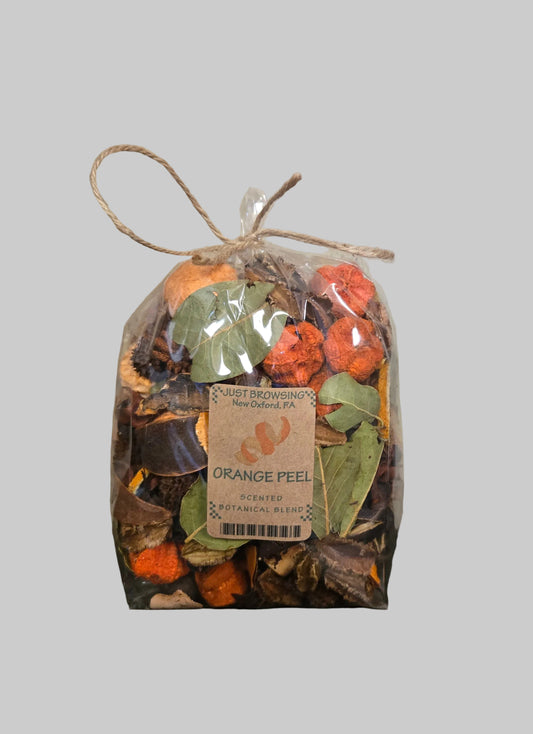 Bag of orange peel potpourri with a label on a wooden surface