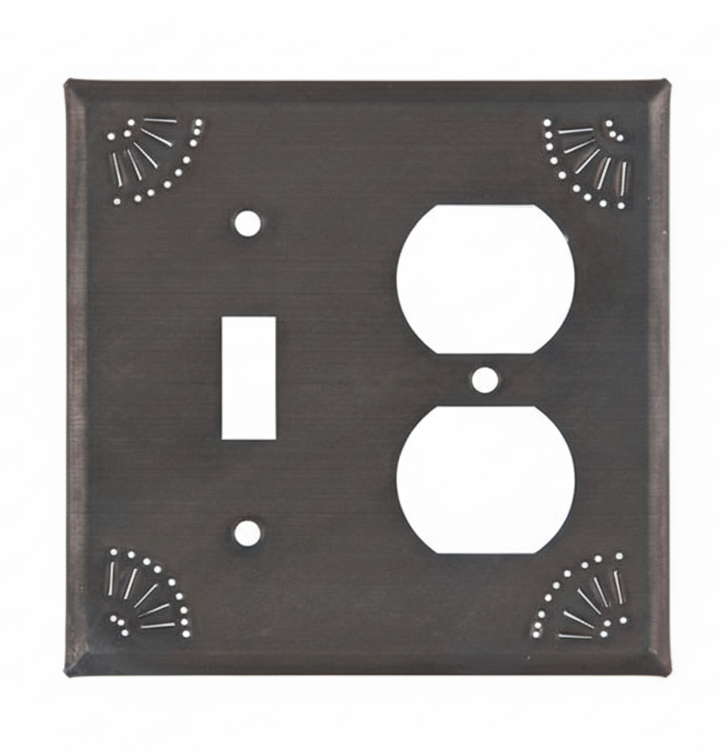 Decorative wall switch plate with two outlets on a white background