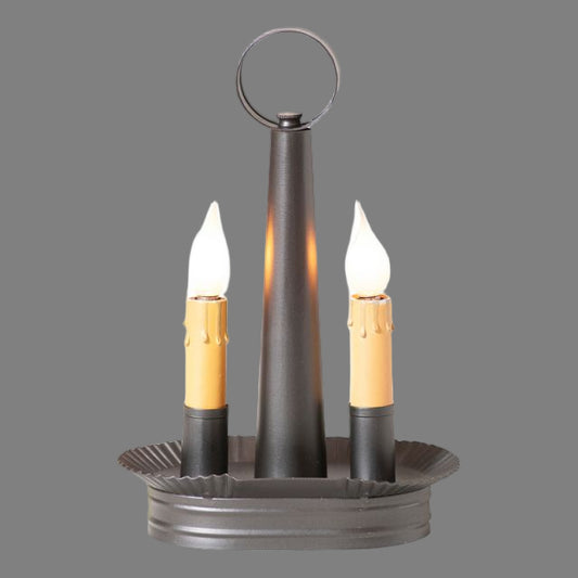 An oval-shaped double accent light in smokey black finish with two bulb sockets, a metal construction, and a circular ring at the top.