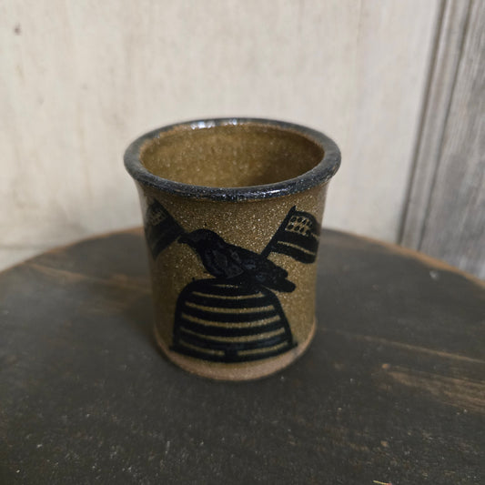 Ceramic cup with decorative band on a neutral background