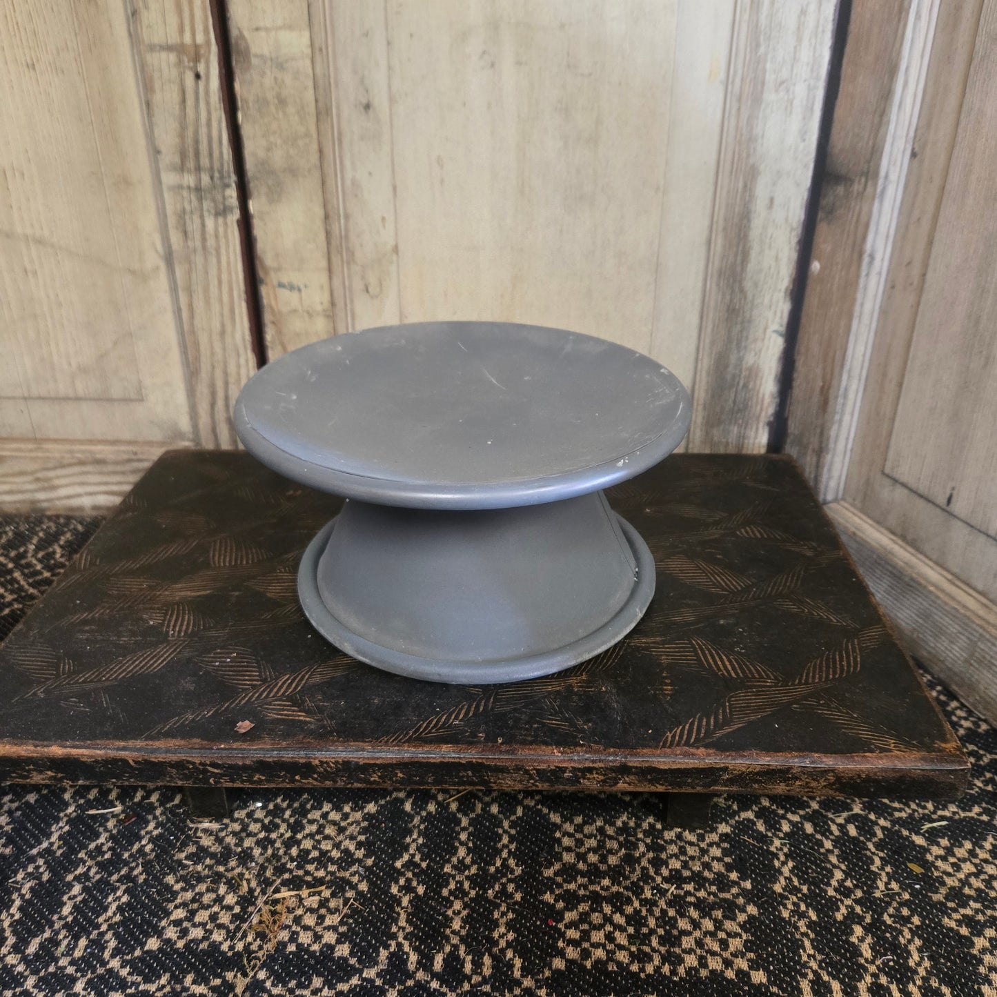 Two gray bowls on a wooden surface with a textured background