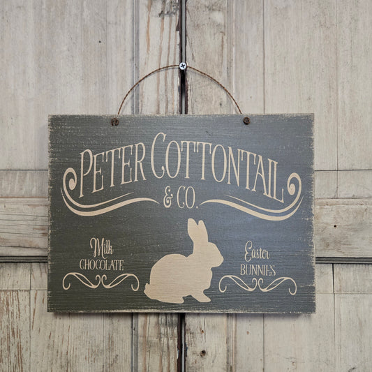 Wooden sign with 'Peter Cottontail & Co' and a bunny silhouette on a wooden background