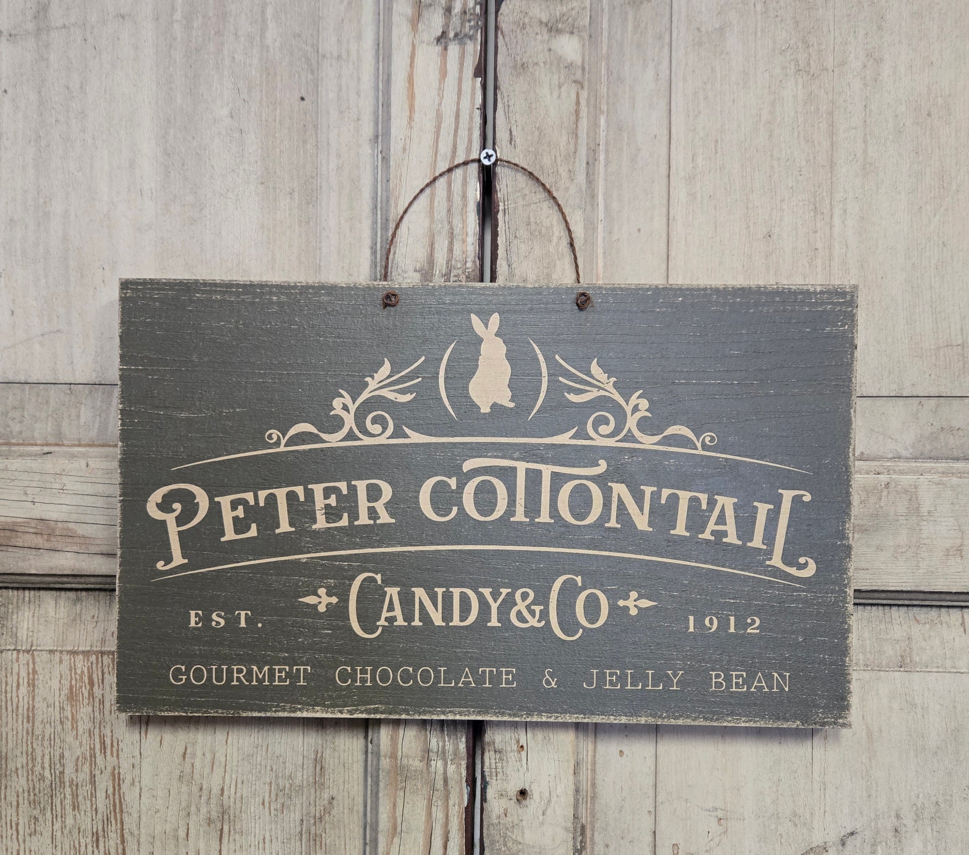 Wooden sign with 'Peter Cottontail Candy & Co' text on a wooden background