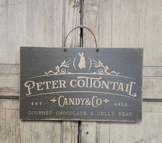 Wooden sign with 'Peter Cottontail Candy & Co' text on a wooden background