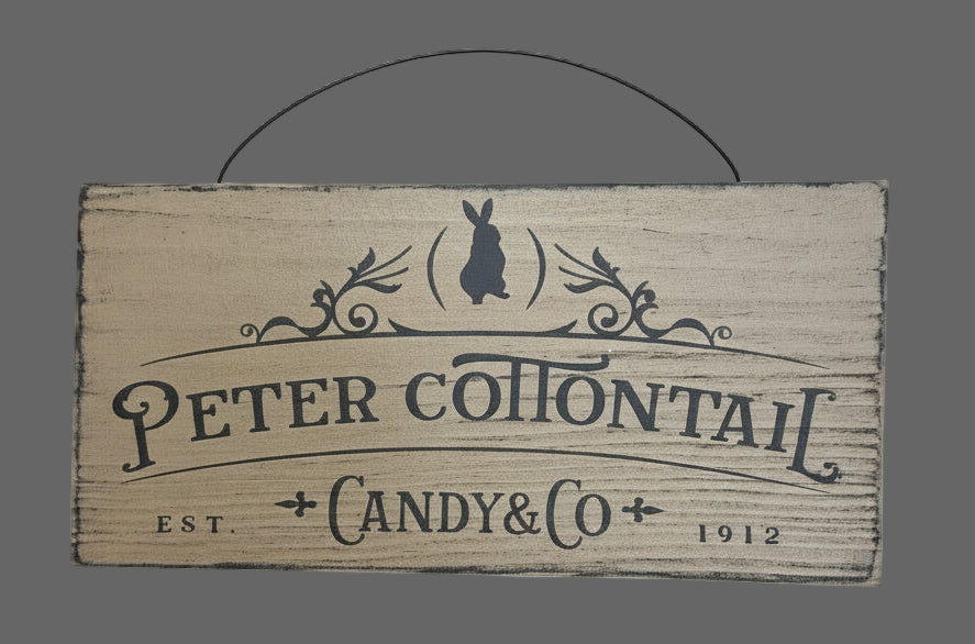 Wooden sign with 'Peter Cottontail Candy & Co' branding on a gray background