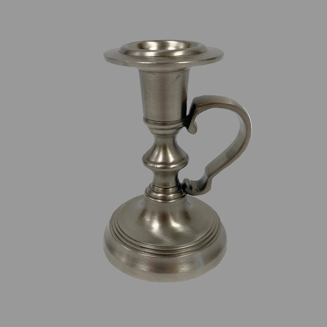 Metallic candle holder with handle on a white background