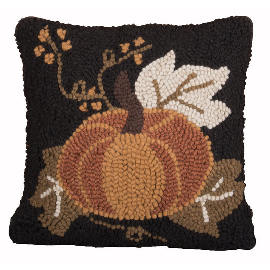 Decorative pillow with a pumpkin design on a black background