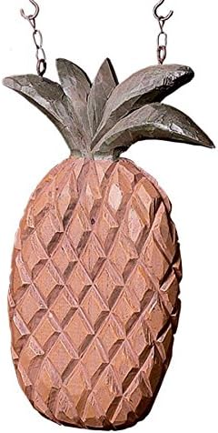 Close up detail of pineapple hanging from chain.
