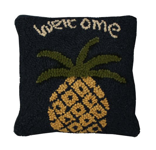 Hooked pillow with pineapple and the word "welcome" on white background