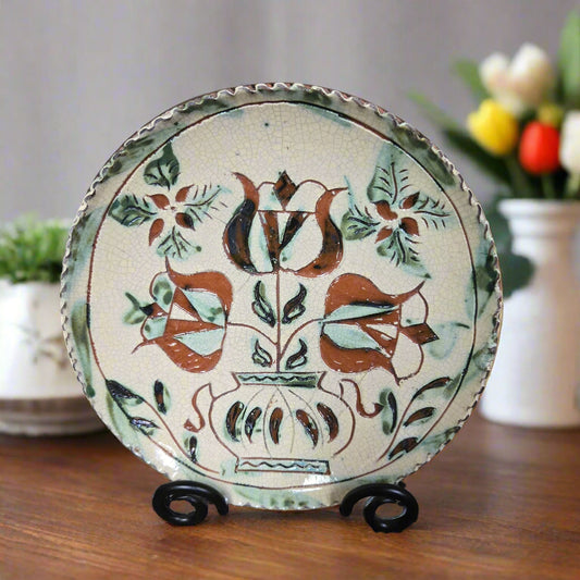 Redware plate with a pot of tulips and a crimped edge
