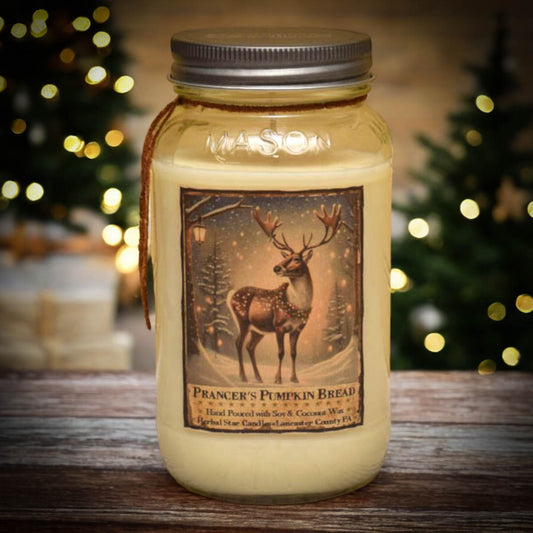 A 24 oz mason jar candle with a label depicting a reindeer and pumpkin, indicating the scent is Prancer's Pumpkin Bread, which is a blend of soy and coconut waxes.