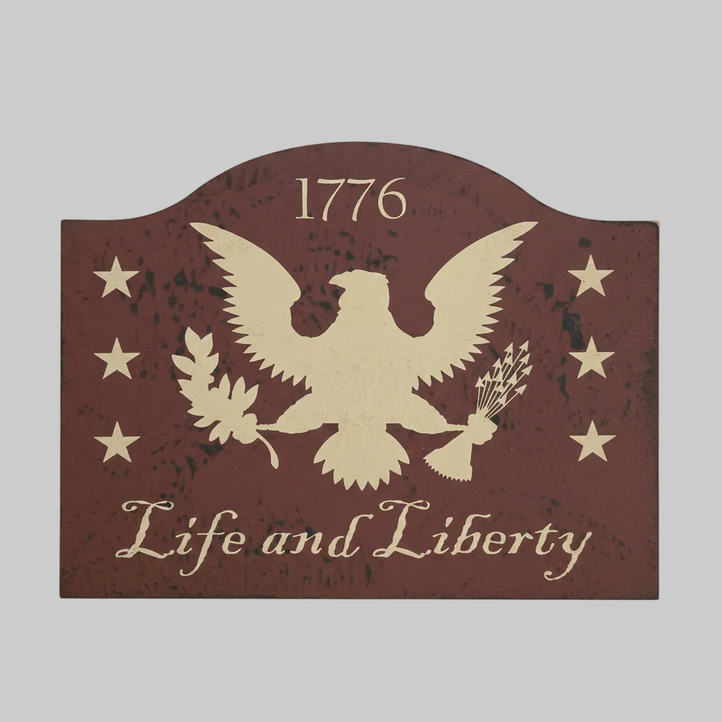 Decorative sign with an eagle and text on a wooden surface