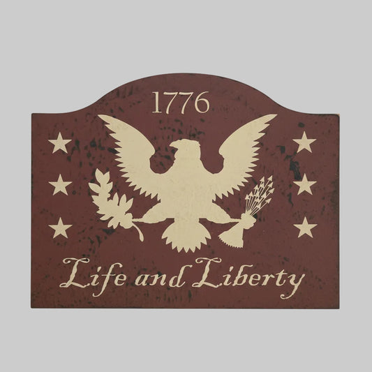Decorative sign with an eagle and text on a wooden surface