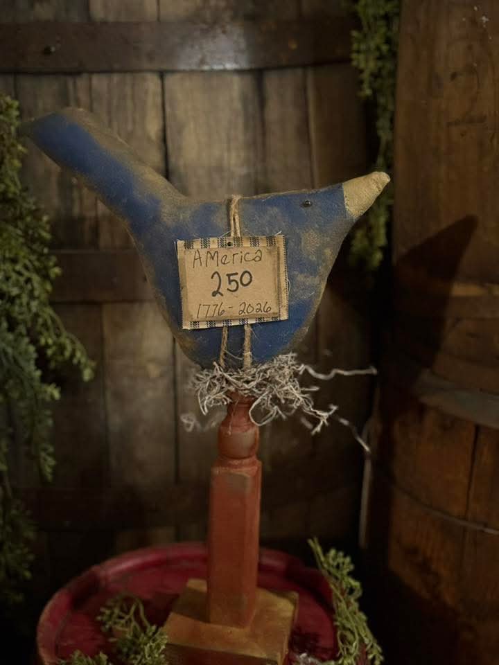Decorative tool with a sign labeled 'America 250' against a rustic wooden background