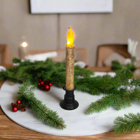Decorative candle with greenery on a table setting