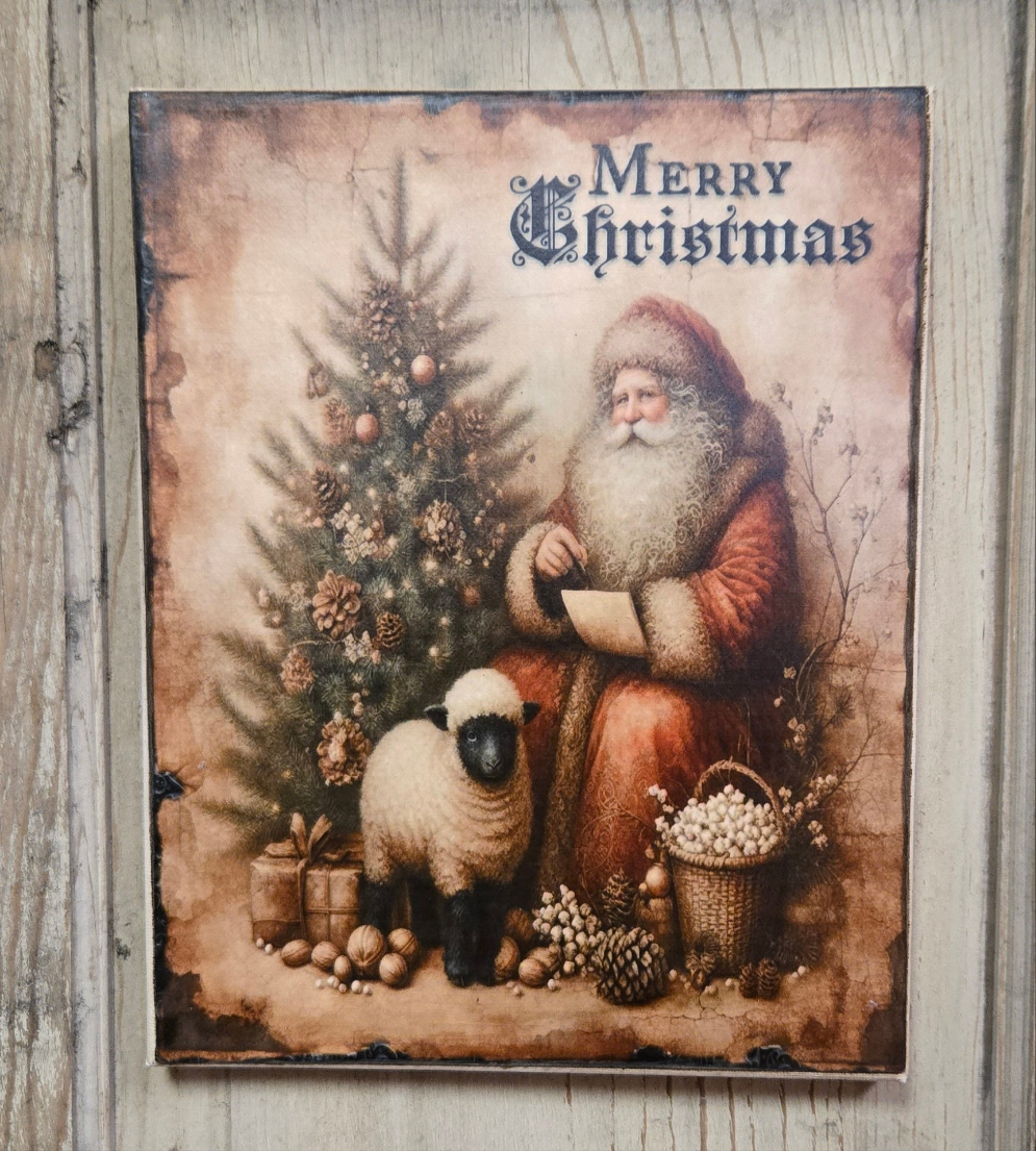 A canvas print featuring a primitive design of Santa Claus with a sheep and a Christmas tree, surrounded by festive decorations, with the text 'Merry Christmas' at the top.