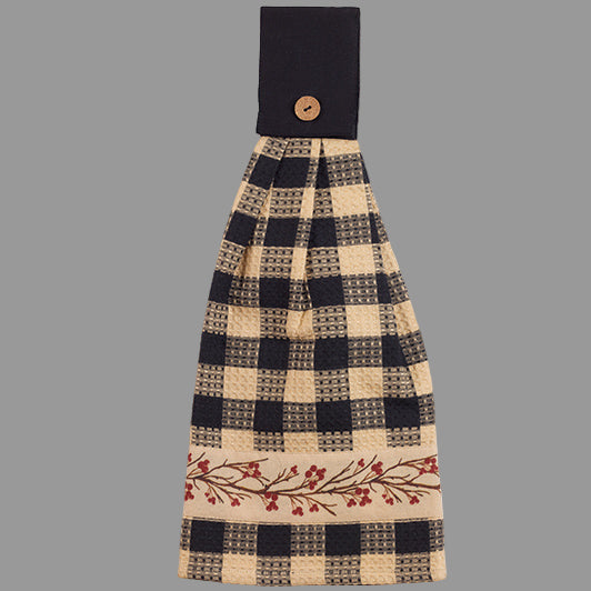Hand towel with checkered design with a band of a berry vine at the bottom and a button tabbed top