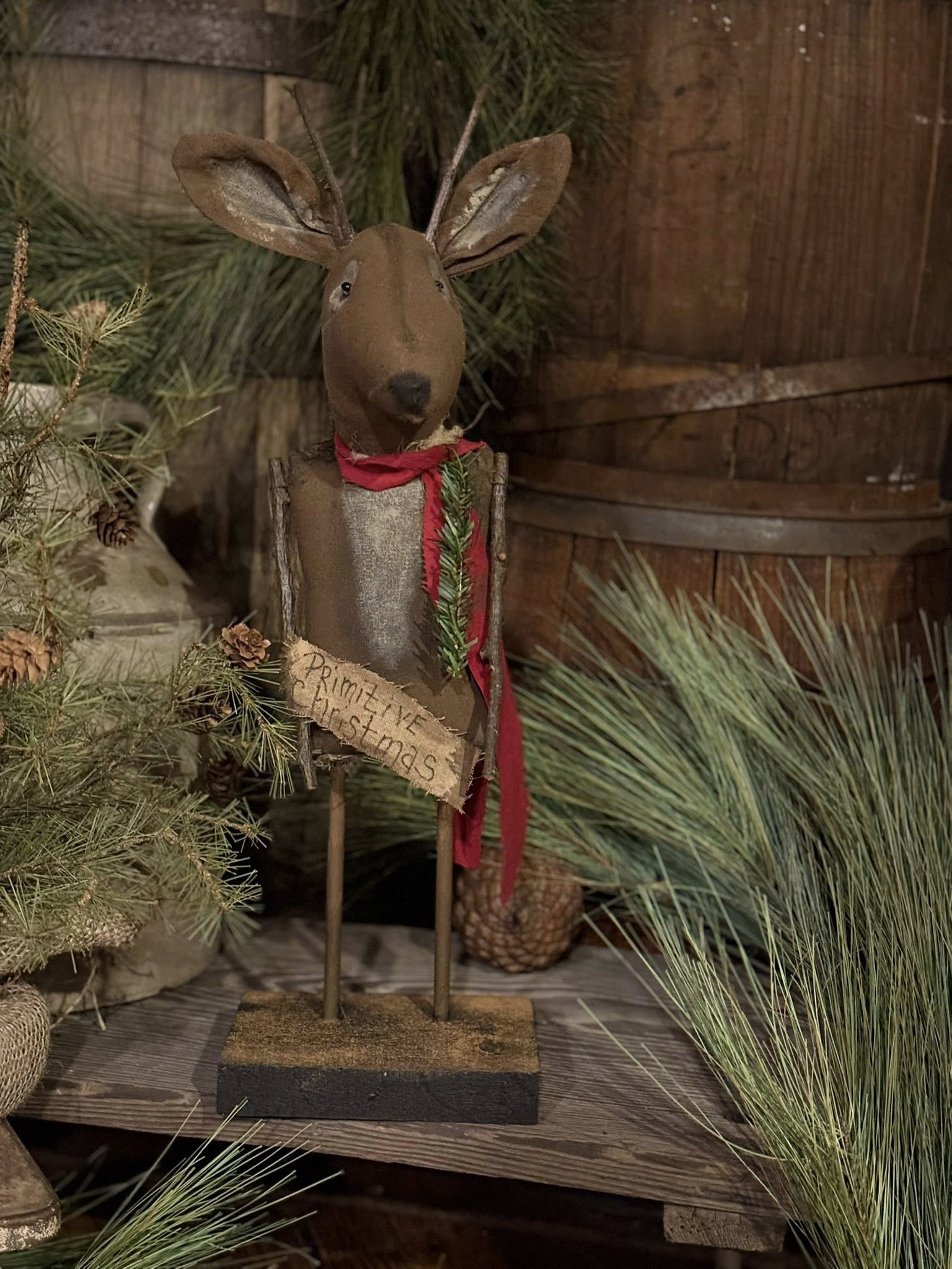 Decorative deer figure with a sign in a rustic setting