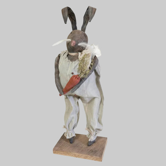 Decorative figure of a rabbit in formal attire on a white background
