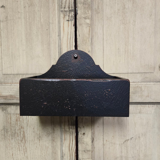 Black wood wall-mounted candle box against a wooden background