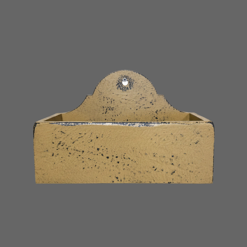 Mustard wooden candle box against a wooden background