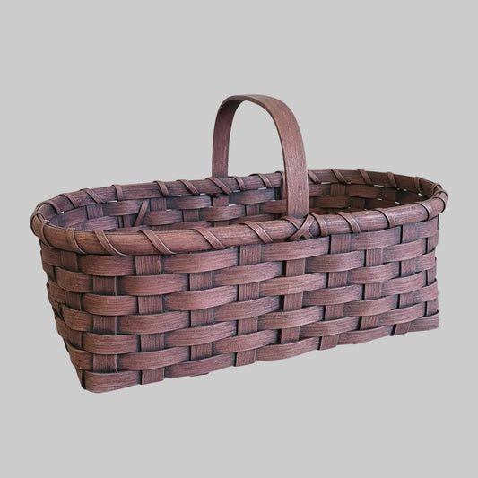 Woven basket with a handle on a wooden surface