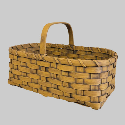 Woven basket with a handle on a wooden surface