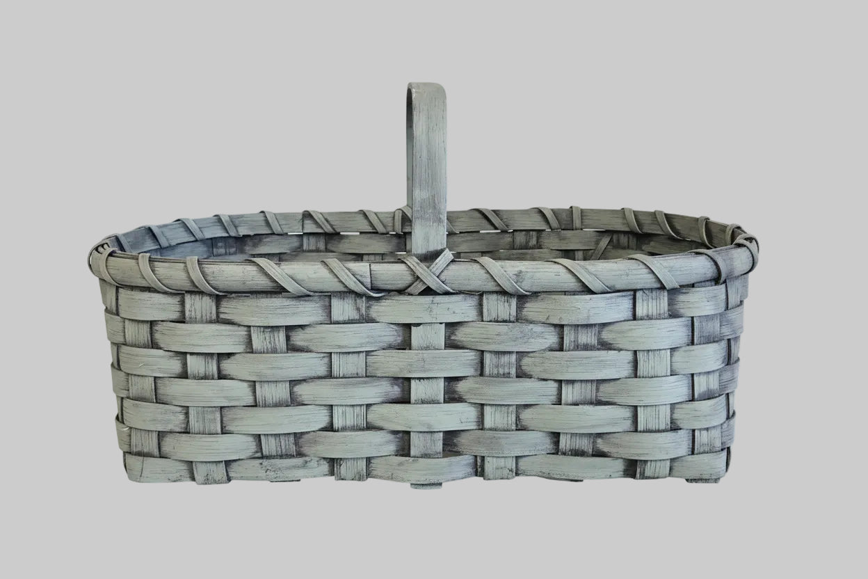 Woven basket with a handle on a wooden surface