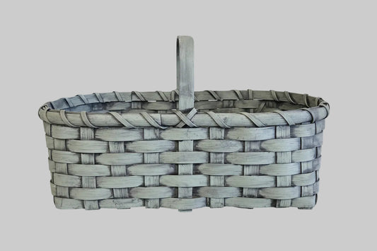 Woven basket with a handle on a wooden surface