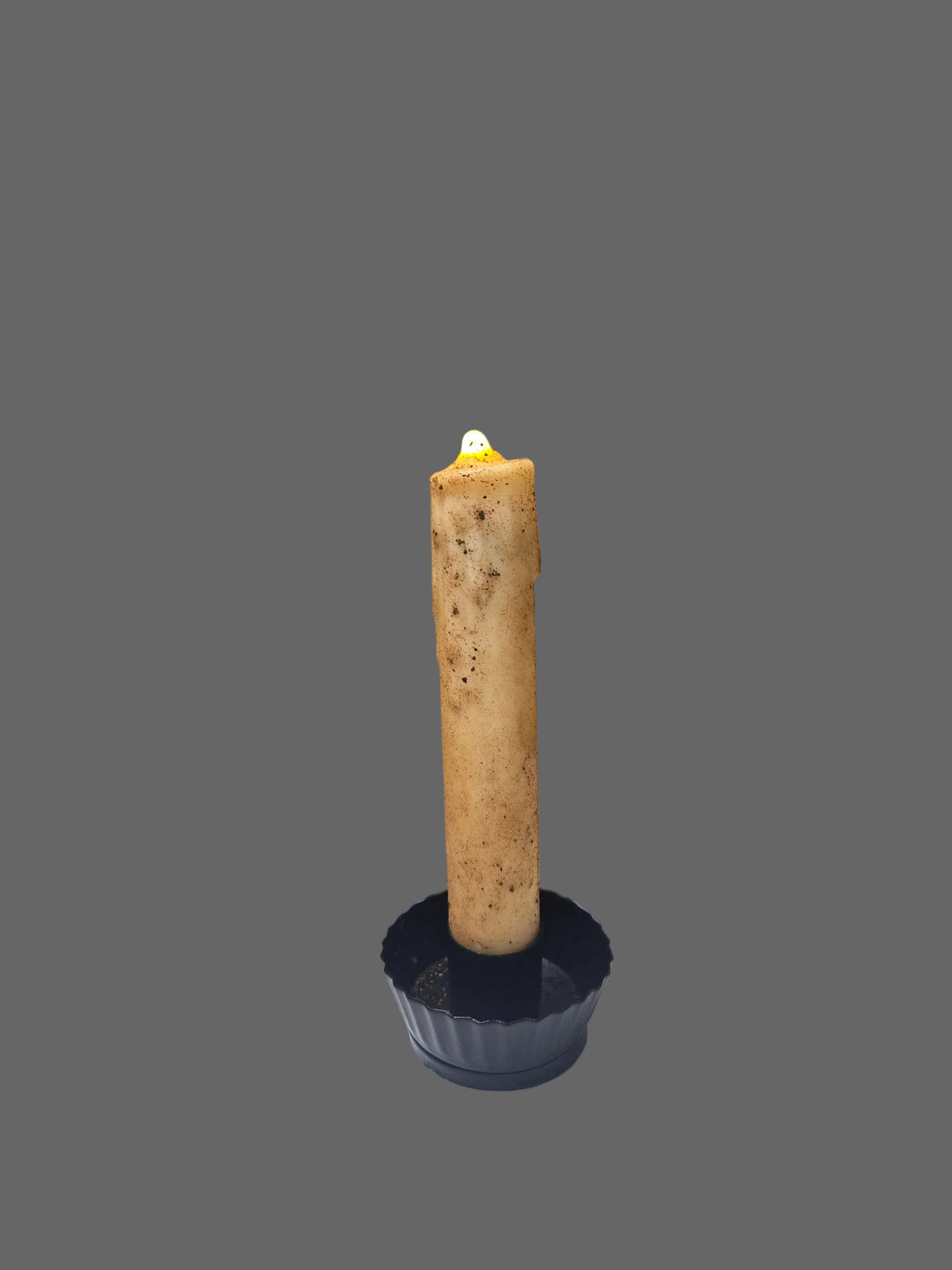 6-inch cream textured LED taper candle with dark speckles and a glowing flame in a dark fluted metal holder.