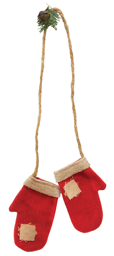 Mittens hanging from jute on a white background.
