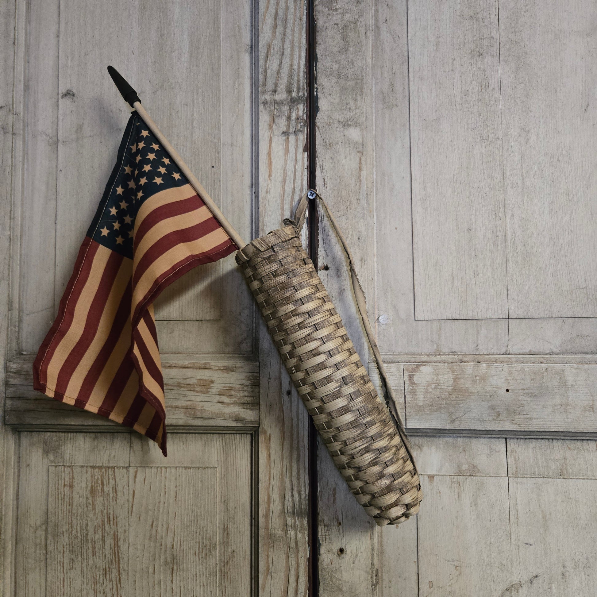 Vintage-style American flag and rifle on a wooden surface