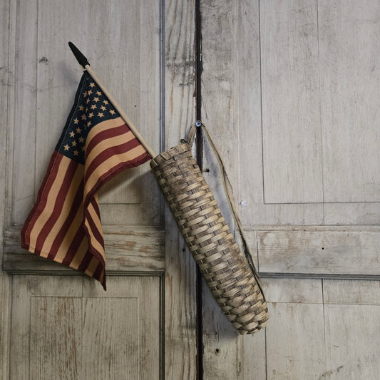 Vintage-style American flag and rifle on a wooden surface