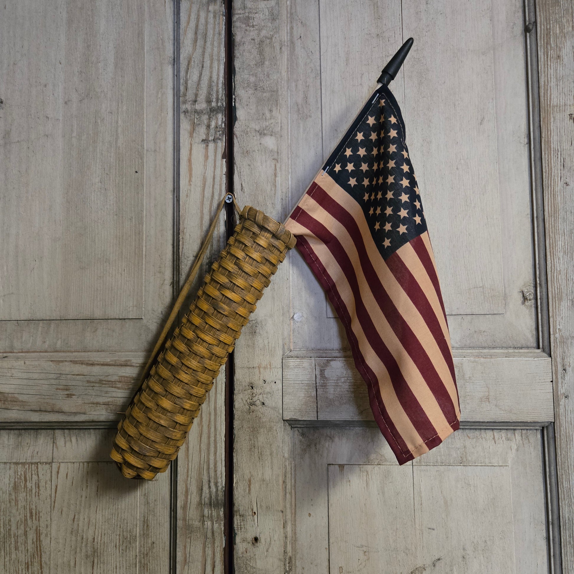 American flag and knotted rope on a wooden surface