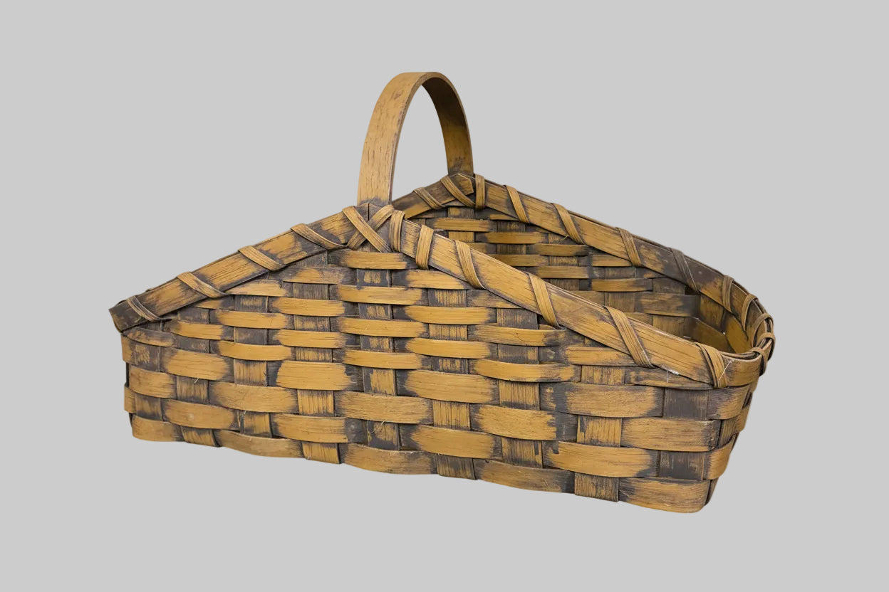 Woven basket with a handle on a textured surface