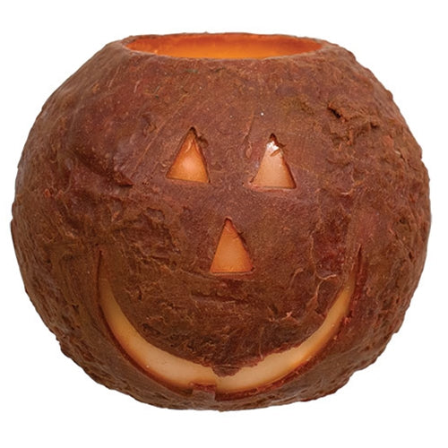Ceramic pumpkin with a carved face on a white background