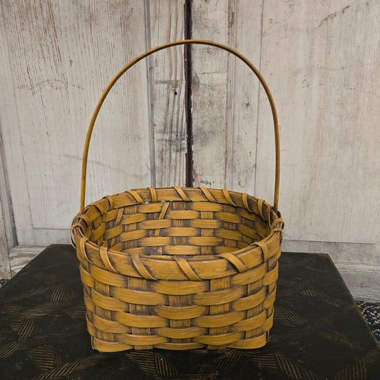 Woven basket with a handle on a wooden surface
