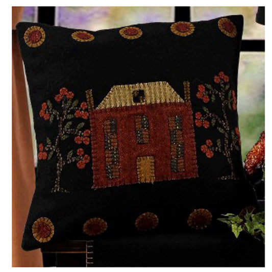 Black throw pillow with house and trees